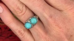 This fascinating twin turquoise cabochon ring is crafted of 18k white gold. This ring is currently a size 7.5. The turquoise show visible epoxy around the stones to help keep them secure. Elegant Turquoise Ring With Polished Finish, Formal Turquoise Ring With Polished Finish, Formal Polished Turquoise Ring, Formal Turquoise Multi-stone Rings, Formal Turquoise Rings With Polished Finish, Turquoise Enamel Ring For Anniversary, Turquoise Enamel Anniversary Ring, Formal Fine Jewelry Turquoise Cabochon Ring, Formal Turquoise Cabochon Ring Fine Jewelry