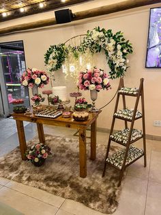 the table is set up with flowers and desserts