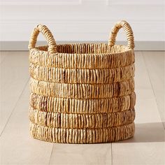 a wicker basket is stacked on the floor and ready to be used as a storage container