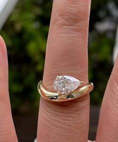 a woman's hand with a diamond ring on it