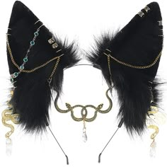 two pieces of black and gold garb with chains, beads and feathers on white background