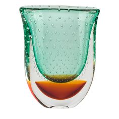 a green glass vase with water drops on the bottom and an orange bowl below it