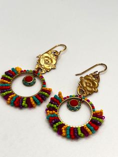 Colorful beaded brass earrings. These are lightweight one of a kind earrings that will go with all of your summer/spring outfits! Artisan Multicolor Beaded Earrings With Gold Beads, Traditional Multicolor Beaded Earrings Nickel Free, Multicolor Brass Beaded Earrings For Festival, Multicolor Beaded Earrings With Gold Beads As Gift, Multicolor Round Beads Earrings With Gold Beads, Artisan Nickel Free Beaded Earrings For Festivals, Traditional Multicolor Beaded Earrings With Gold Beads, Colorful Nickel Free Bohemian Jewelry, Festive Multicolor Beaded Hoop Earrings