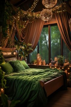 a bed with green sheets and pillows in front of a large window filled with lights