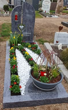 a grave yard with flowers and rocks in the shape of an arrow is shown here