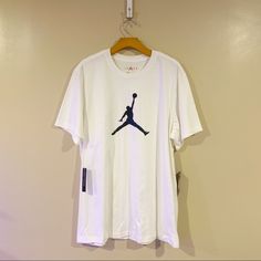 White T-Shirt Blue Jordan Emblem On The Front Design On The Lower Back Brand New Nike Cotton Short Sleeve Tops, Nike Casual Short Sleeve T-shirt, Nike Short Sleeve T-shirt, Nike White Tops For Summer, White Crew Neck Graphic Tee, Casual Nike Short Sleeve Tops, Nike Short Sleeve Summer Shirt, Nike Short Sleeve Shirt For Summer, Nike Cotton Crew Neck Shirt