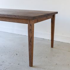 a wooden table sitting on top of a white floor