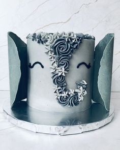 a white cake decorated with black icing and flowers