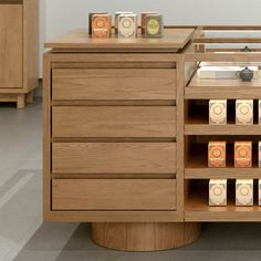 a wooden cabinet filled with lots of different types of boxes on top of it's drawers