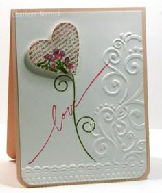 a close up of a greeting card with a heart and flowers on the inside of it