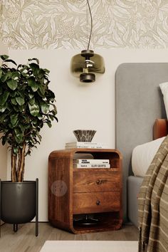 a bed room with a plant and a nightstand