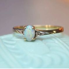 a white opal ring sitting on top of a table