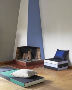 a living room filled with furniture and a fire place next to a wall mounted fireplace