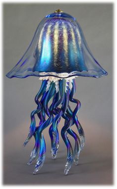 a glass jellyfish lamp sitting on top of a table