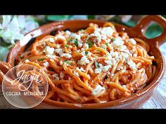 a bowl filled with pasta and cheese on top of a table