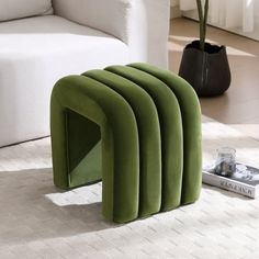 a green bench sitting on top of a white rug