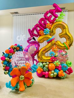 the balloons are in the shape of numbers and flowers on the floor next to each other