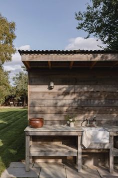 a wooden shed with a sink on the outside