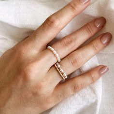 This dainty ring is made from a string of mini freshwater pearls and is perfect for stacking or wearing on its own. It is designed to be slightly stretchy, making it comfortable to wear on different fingers. For pinky rings, we suggest sizing 2 sizes down from your ring finger size. Save 20% when you shop our best selling pearl ring stack set. Measurements: 3mm pearls Waterproof & tarnish resistant Pearl Ring Stack, Everyday Pearl Jewelry With Tiny Beads, Dainty Hypoallergenic Pearl Ring For Everyday, Dainty Everyday Hypoallergenic Pearl Ring, Minimalist Adjustable Pearl Ring With Charm, Minimalist Pearl Jewelry With Tiny Beads, Minimalist Everyday Stackable Pearl Ring, Adjustable Everyday Pearl Drop Rings, Adjustable Pearl Charm Rings For Everyday Wear