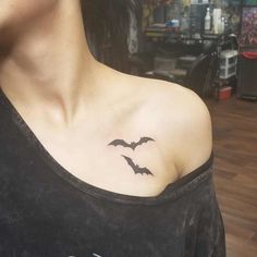 a woman with a bat tattoo on her chest