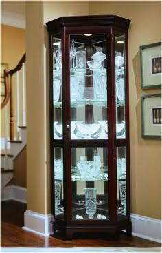 a wooden china cabinet with glass doors