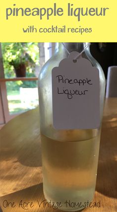 a bottle of pineapple liqueur sitting on top of a table next to a sign