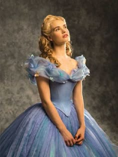 a woman in a blue dress posing for a photo