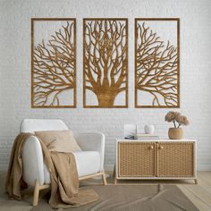 a living room with two white chairs and a brown tree wall art on the wall