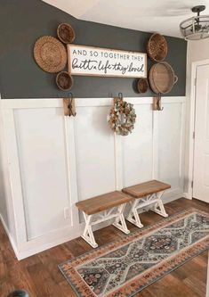 two benches are in front of a wall with baskets on it