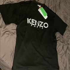 Authentic Kenzo Paris T-Shirt. Size: Medium. Condition: New With Tags Black Designer Logo Crew Neck T-shirt, Black Designer Logo Crew Neck Top, Black Crew Neck T-shirt With Designer Logo, Black Crew Neck Top With Designer Logo, Black Crew Neck Tops With Designer Logo, Casual Designer Logo Tops For Streetwear, Casual Tops With Designer Logo For Streetwear, Black Designer Logo Top For Streetwear, Designer Logo Crew Neck T-shirt For Streetwear