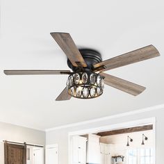 a ceiling fan that is hanging from the ceiling in a room with white walls and wood floors