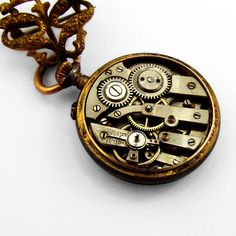 "Antique small open face Swiss pocket watch, having round form 800 silver case, decorated with light blue guilloche enamel. On the back, there are gold floral patterns with a bird in the middle. Watch has white color face with black Arabic numerals, gold dot hour marks and two hands. It comes with a gold-filled figural scroll form watch pin. This glorious watch is 1 1/16\" in diameter, pin is 7/8\" tall and 13/16\" wide. Watch needs cleaning. Eb9327" Steampunk Pocket Watch With Metal Dial, Steampunk Style Metal Dial Pocket Watch For Gift, Steampunk Pocket Watch With Metal Dial As Gift, Steampunk Style Pocket Watch With Metal Dial As Gift, Steampunk Engraved Pocket Watch As Gift, Antique Pocket Watch With Locket, Victorian Style Chronometer Watch For Gift, Victorian Style Chronometer Watch As Gift, Timeless Skeleton Dial Pocket Watch As Gift