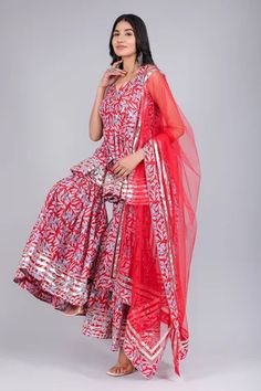 Red floral print anarkali featuring a sweetheart neckline and sleeveless design. Paired with a coordinating sharara and printed hem dupatta adorned with metallic stripes., Fit: Relaxed Designer Red Sharara With Sheer Dupatta, Semi-stitched Red Bollywood Palazzo Set, Red Palazzo Set With Sheer Dupatta For Diwali, Red Anarkali Palazzo Set With Sheer Dupatta, Red Anarkali Sharara With Sheer Dupatta, Bollywood Style Red Palazzo Set For Wedding, Red Bollywood Palazzo Set For Wedding, Anarkali Red Sharara With Pallu, Red Bollywood Palazzo Set With Dupatta