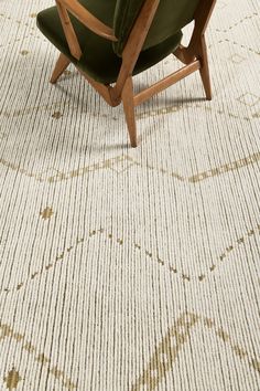 a green chair sitting on top of a rug