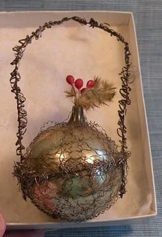 a silver ornament in a box on a table