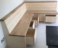 the bench is made out of plywood and has drawers on each side for storage