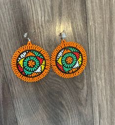 These gorgeous traditional beaded Zulu disc earrings are a gorgeous statement piece must haves.  Please note each piece is handmade and slight variations may occur. Beaded Round Clip-on Earrings, Artisan Orange Beaded Earrings, Artisan Orange Round Bead Earrings, Traditional Festive Beaded Earrings With Colorful Beads, Traditional Orange Beaded Earrings For Gift, Handmade Traditional Orange Beaded Earrings, Traditional Beaded Hoop Earrings, Artisan Beaded Earrings For Festive Occasions, Festive Beaded Round Earrings