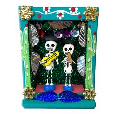 two skeleton figurines holding a surfboard in front of a green frame with gold accents