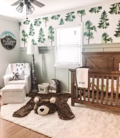 a baby's room with a teddy bear rug, crib and rocking chair