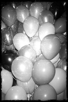 black and white photograph of many balloons