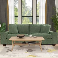 a living room scene with focus on the couch and coffee table in front of the window