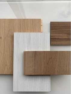 some wood and white tiles on a wall