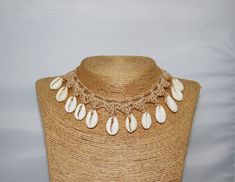 This beige boho crochet woollen necklace is hand crafted with natural cowrie shells and a macrame knot so the length is adjustable. Hello, wonderful customers! When it comes to shipping, standard shipping is a popular choice. If you choose standard shipping without tracking and your package goes missing in the potential  postal abyss, we won't be able to refund or replace it. Therefore, we highly recommend upgrading to our tracked shipping option so that your parcel stays on your radar and you r Hello Wonderful, Crochet Choker, Beige Crochet, Beige Boho, Cowrie Shells, Macrame Knot, Cowrie Shell, Boho Crochet, Choker Necklaces