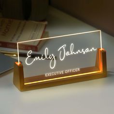 an illuminated business name sign on a desk