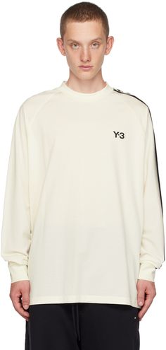 Stretch cotton jersey T-shirt. · Rib knit crewneck and cuffs · Logo bonded at chest · Vented side seams · Raglan sleeves · Stripes at sleeve Supplier color: Off-white/Black Knit Crewneck, Striped Long Sleeve, Jersey T Shirt, Raglan Sleeve, Stretch Cotton, Apparel Accessories, Long Sleeve T Shirt, Rib Knit, Shirts Tops