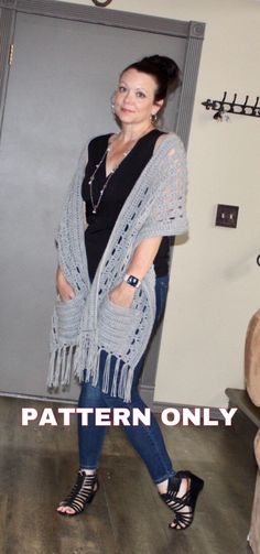 a woman in black shirt and blue jeans standing next to a gray door with the words pattern only written on it