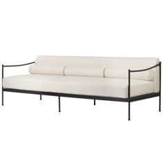 a white couch sitting on top of a metal frame