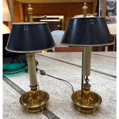 two lamps sitting on top of a table next to each other