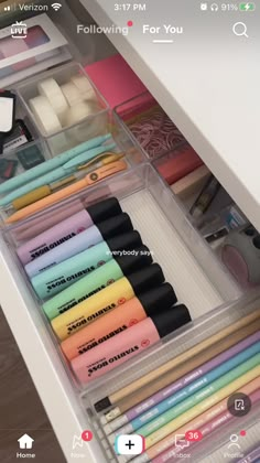 the drawers are organized with markers, pens and pencils