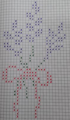 a cross stitch pattern with red, green, and blue crosses in the center on white paper